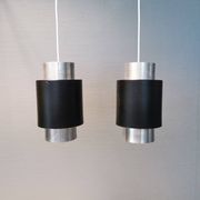 A set of beautiful cylinder shaped hanging lamps in silver color with black "ring" Danish 1970s.