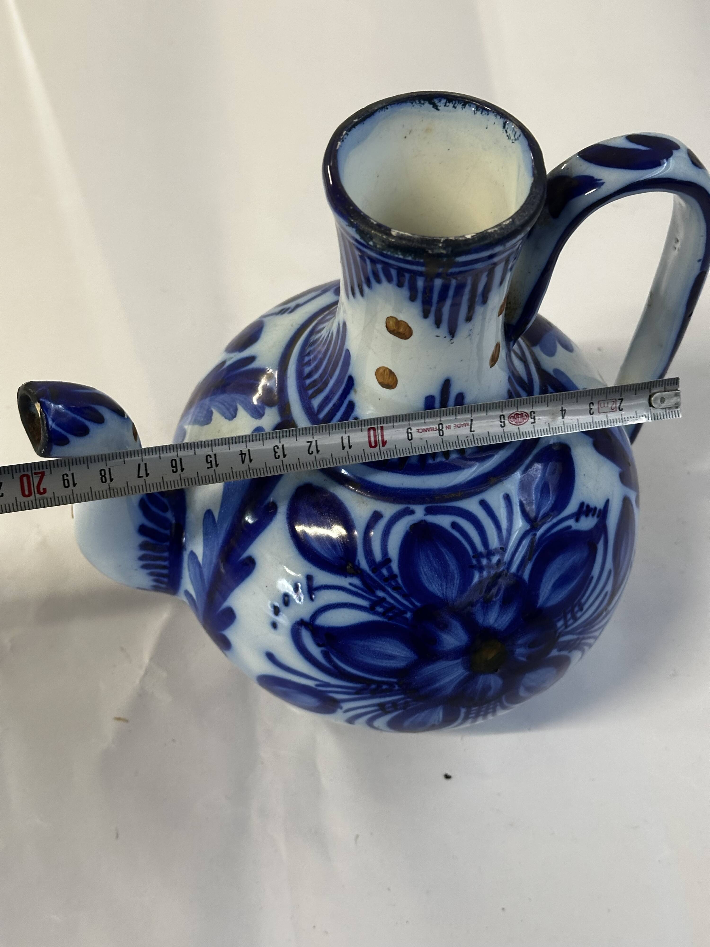 Glazed ceramic carafe with floral decoration