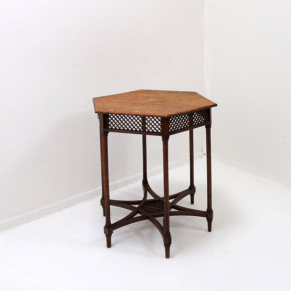 Hexagonal pedestal table or side table with a lattice structure and star pattern.