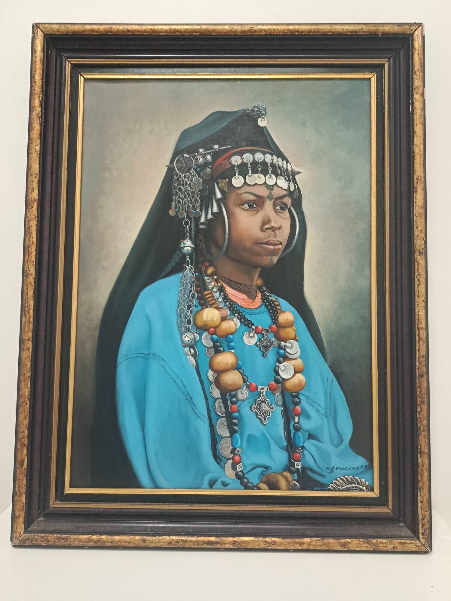 Portrait of a young Moroccan woman in traditional attire and adornments.