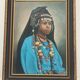 Portrait of a young Moroccan woman in traditional attire and adornments.
