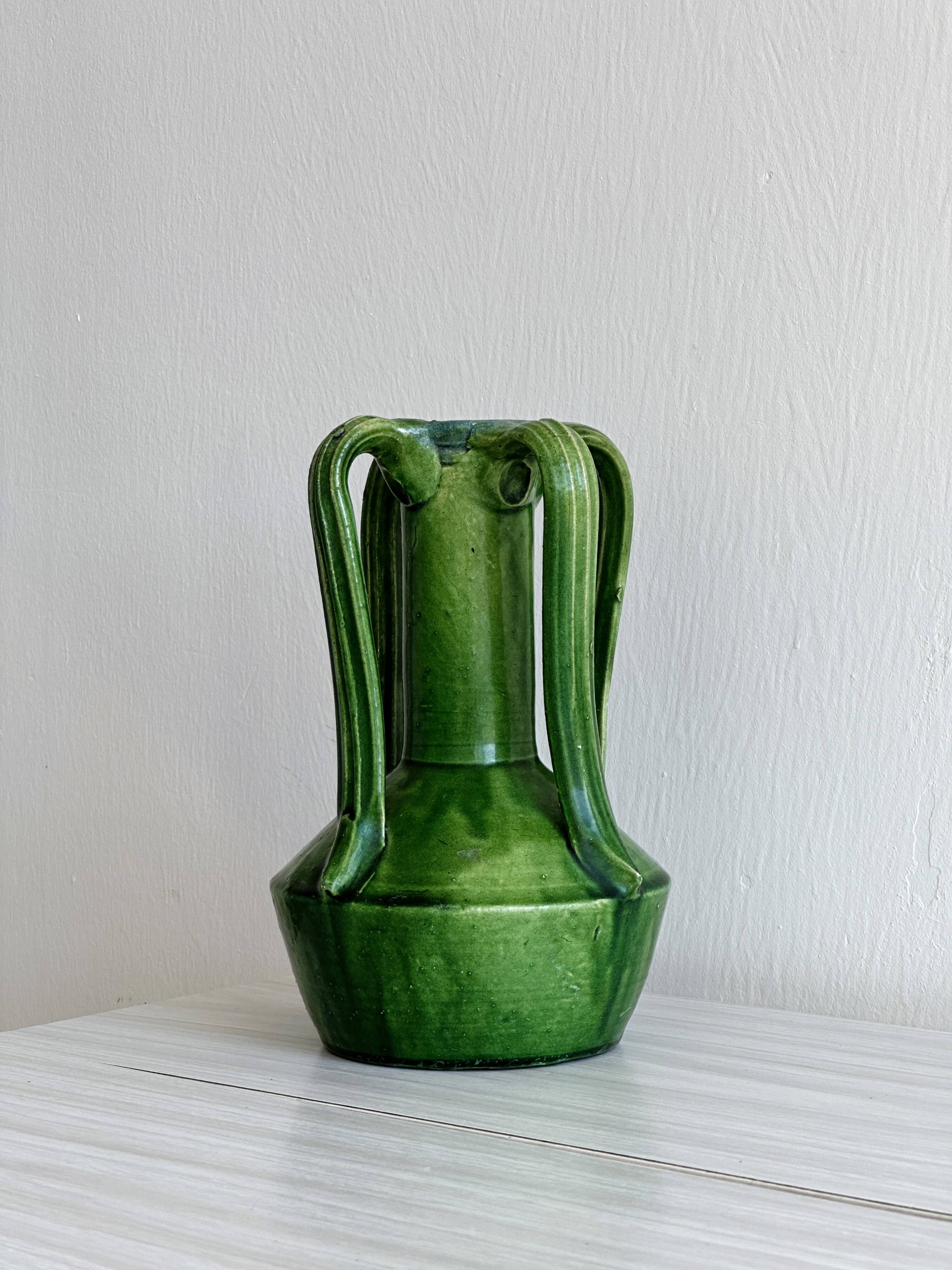 Pottery green ceramic vase with four handles.