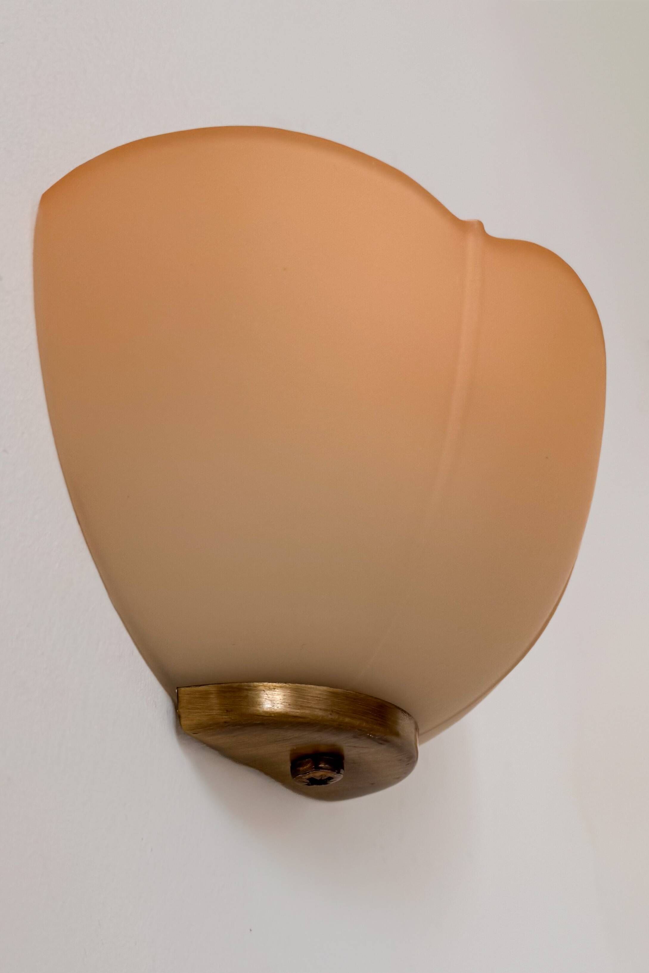 Vintage brass and orange glass wall lights, France 1970.