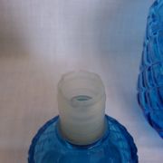 Turquoise glass carafe bottle with a stopper.