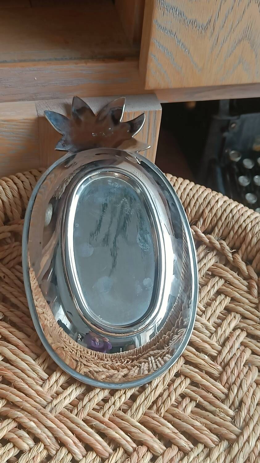 Silver-plated metal tray in the shape of a pineapple.