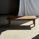 Brown Indonesian teak coffee table, with a border and cylindrical legs H40 L103.