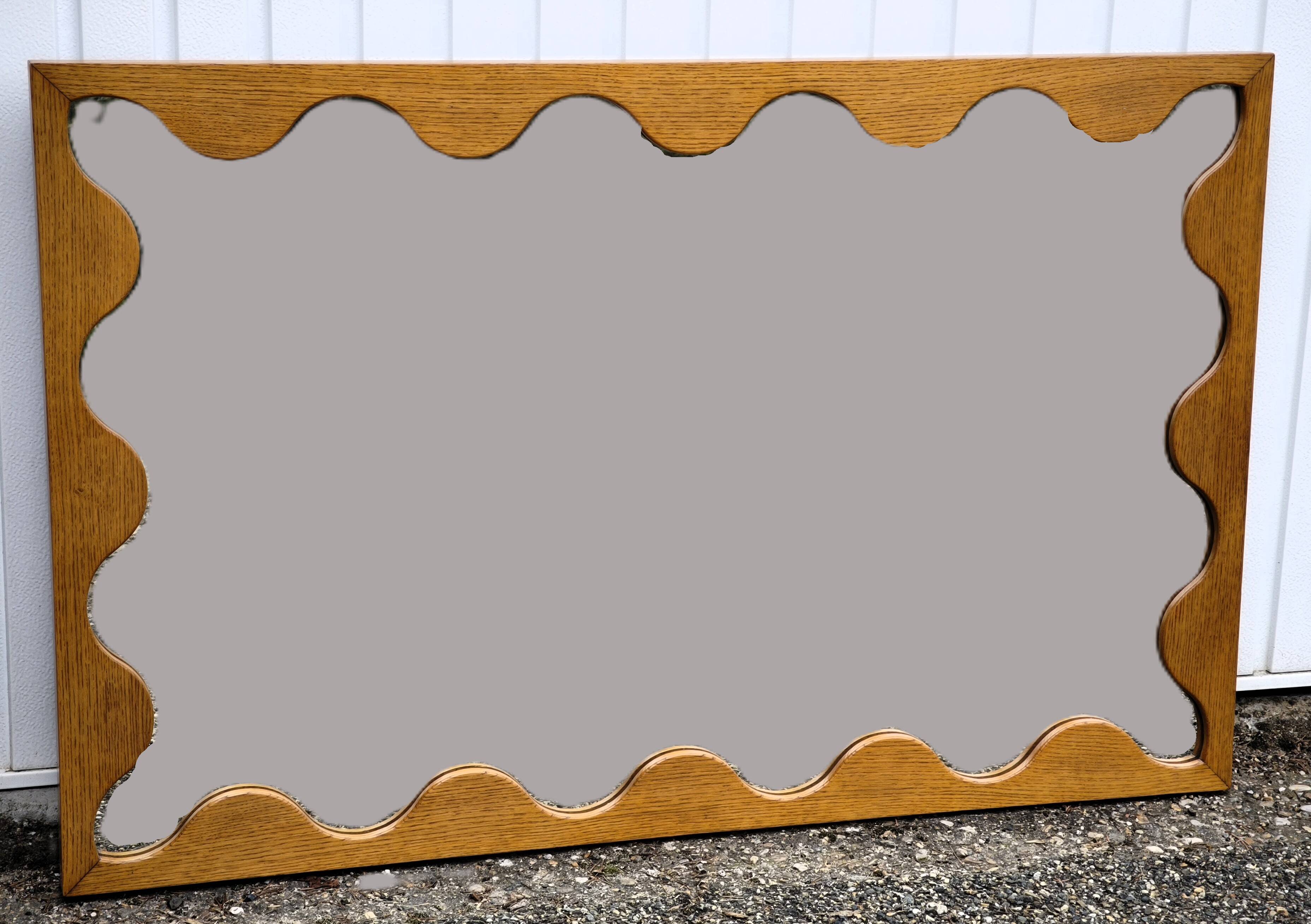 Large antique mirror with an oak frame.