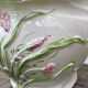 White ceramic pot cache of flower slip and old green foliage
