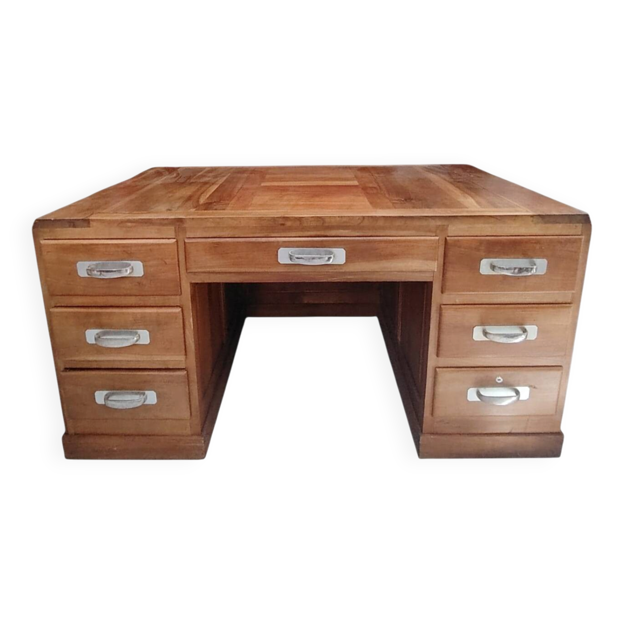 Large modernist minister's desk in solid lemon wood with 7 drawers.