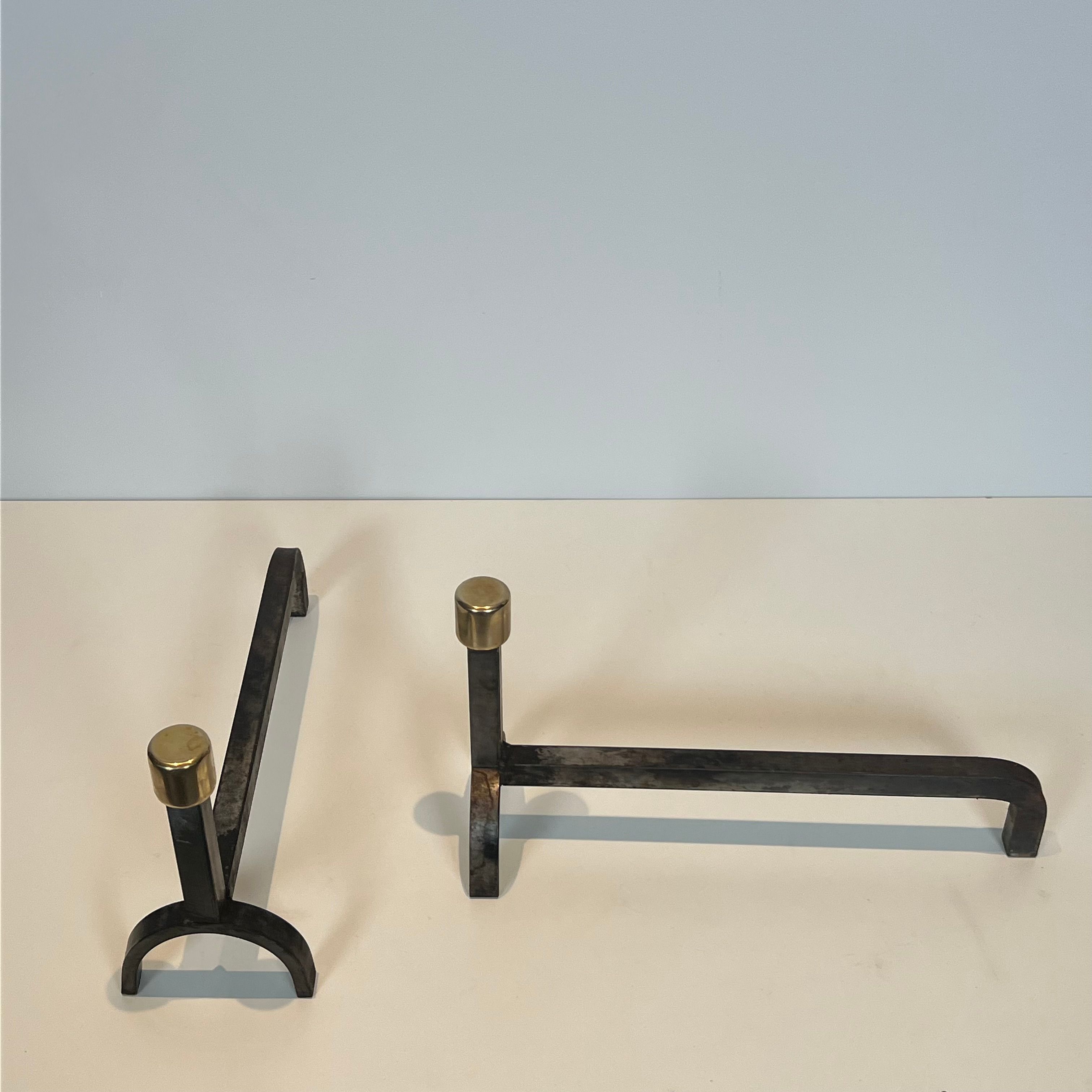 Pair of modernist fire dogs in wrought iron and brass