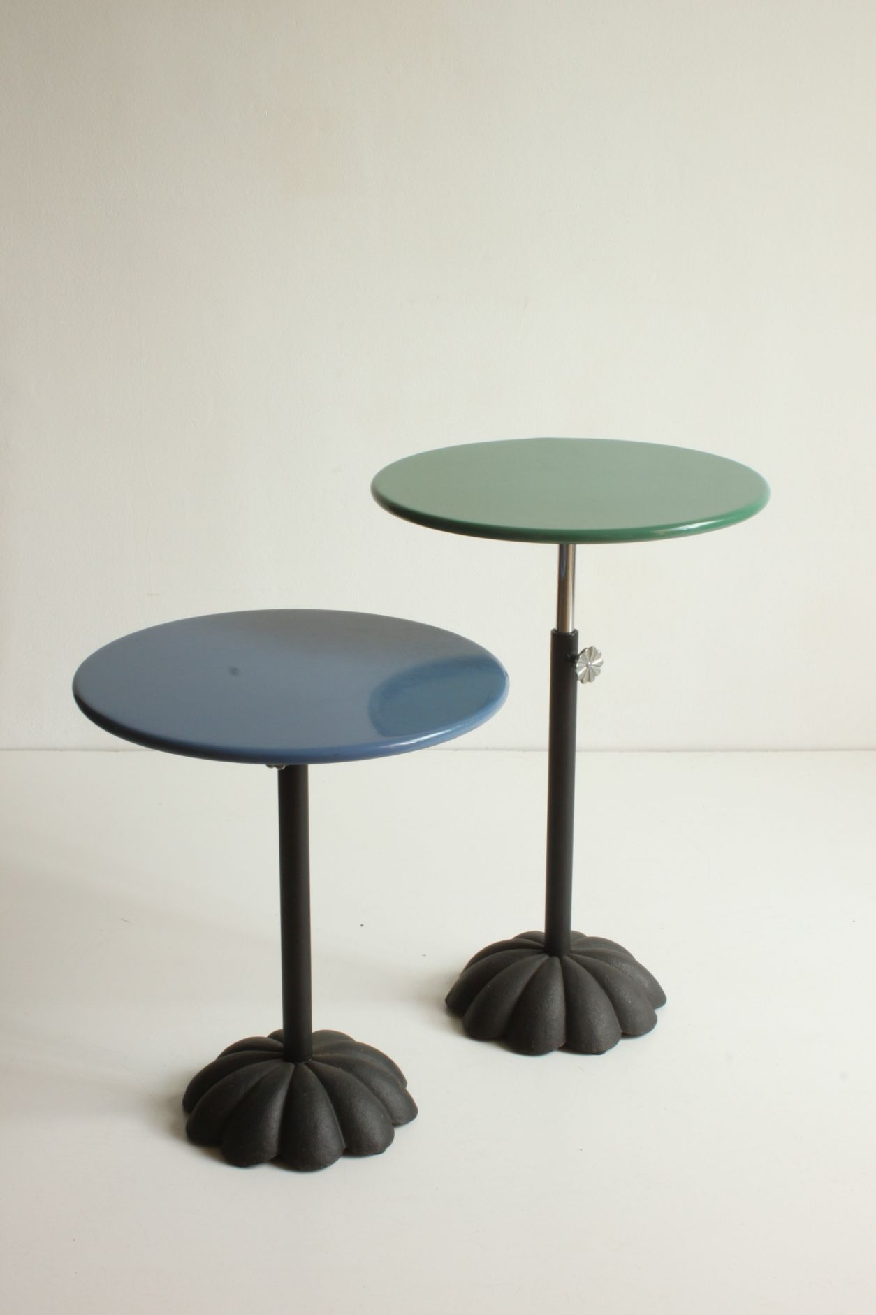 Postmodern cast iron flower base adjustable round side tables, blue and green, 1980s.