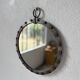 Brutalist round mirror with wrought iron and studs.