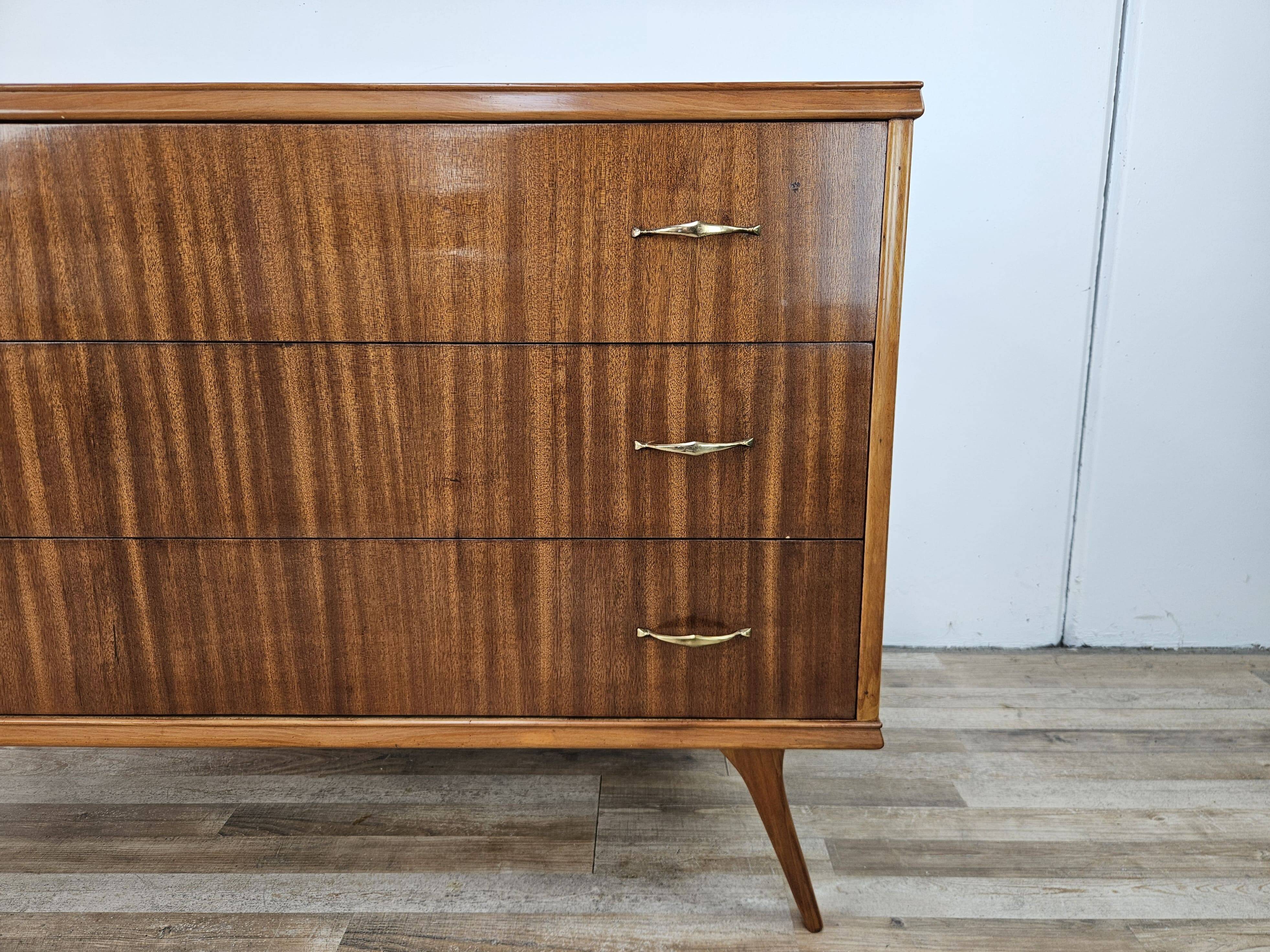 1950s chest of drawers covered in walnut with brass handles