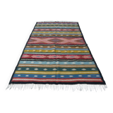 Traditional Berber tribal kilim rug with multicoloured geometric patterns.