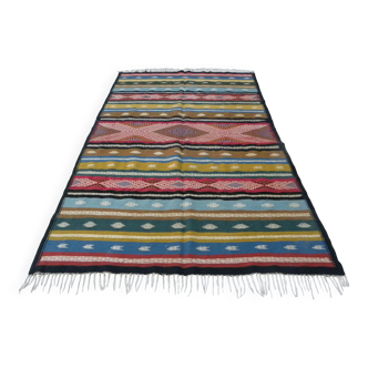 Traditional Berber tribal kilim rug with multicoloured geometric patterns.
