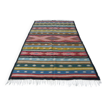 Traditional Berber tribal kilim rug with multicoloured geometric patterns.