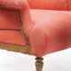 Napoleon III salon armchair in brick red linen with a tufted footrest.