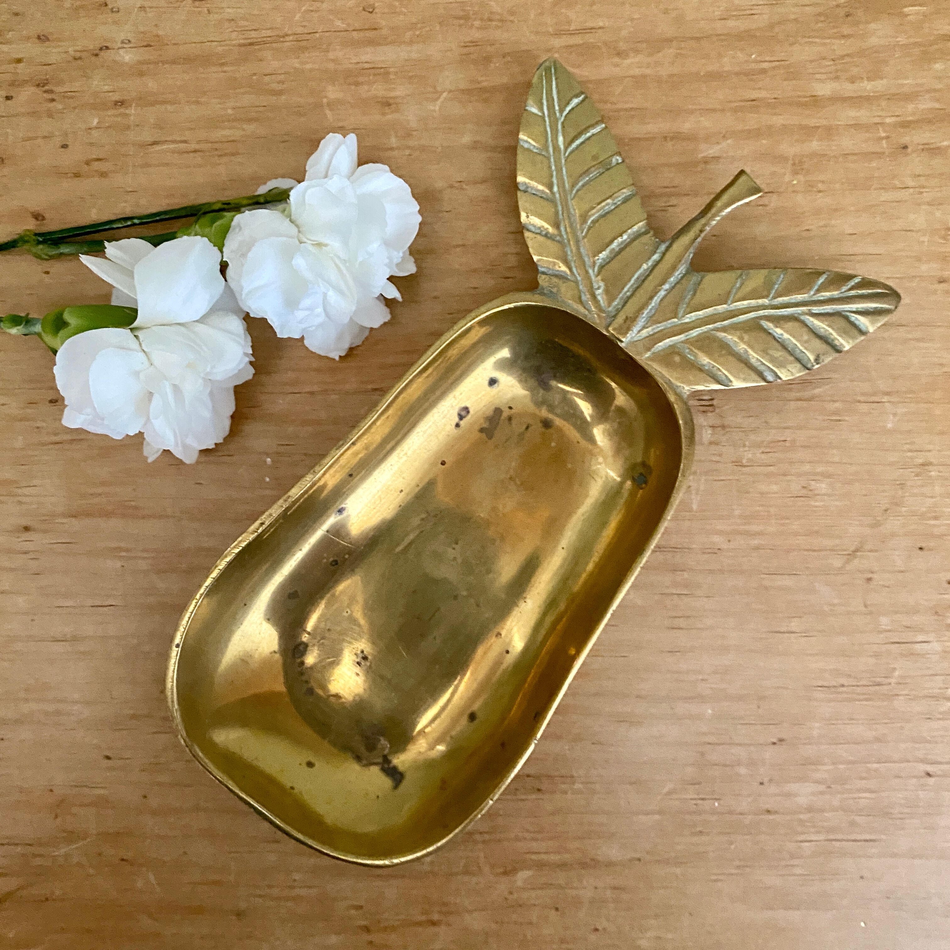 Empty vintage pear-shaped brass pocket