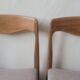 Pair of Scandinavian teak chairs sitting beige gray fabric