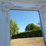 Large wooden mirror on tilting psyche stand in whitewashed gold with molding
