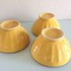 Suite of three yellow ribbed bowls with blue / vintage 70s border