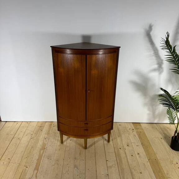 Mid-century modern corner furniture in teak with doors.