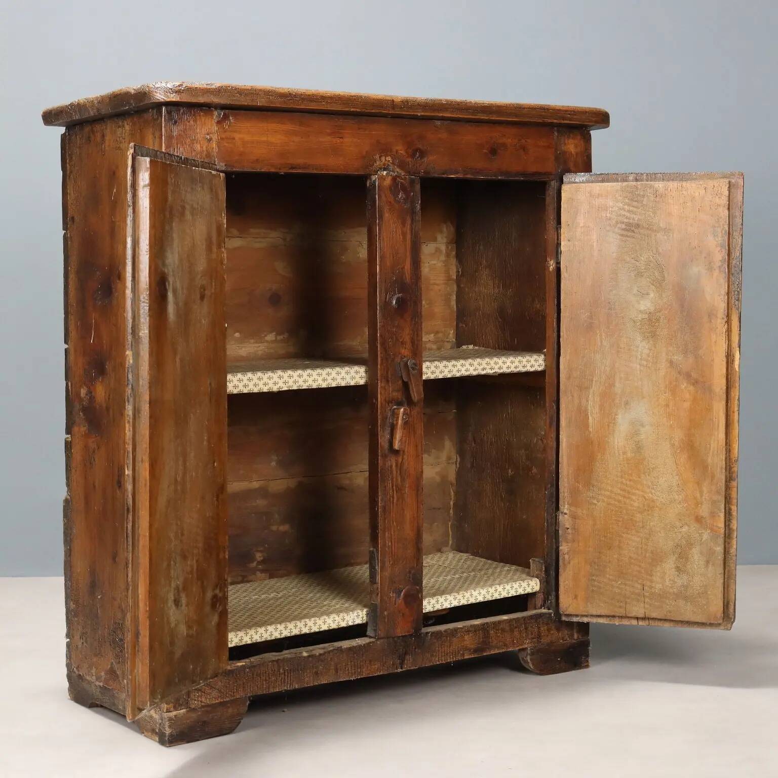 Antique pine wardrobe painted in walnut stain, restorations, Italy, 17th century.