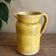 Old yellow glazed terracotta jug from southern France.
