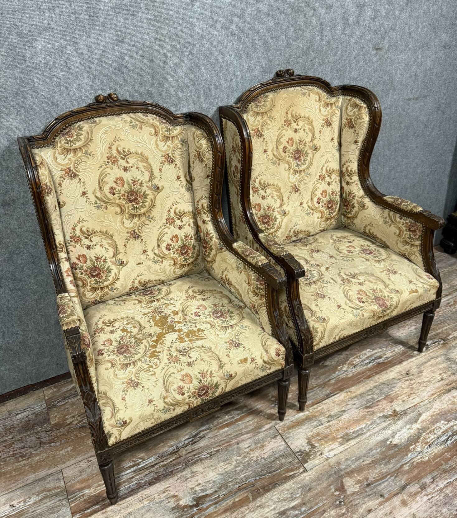Large pair of Louis XVI style carved wooden wingback armchairs