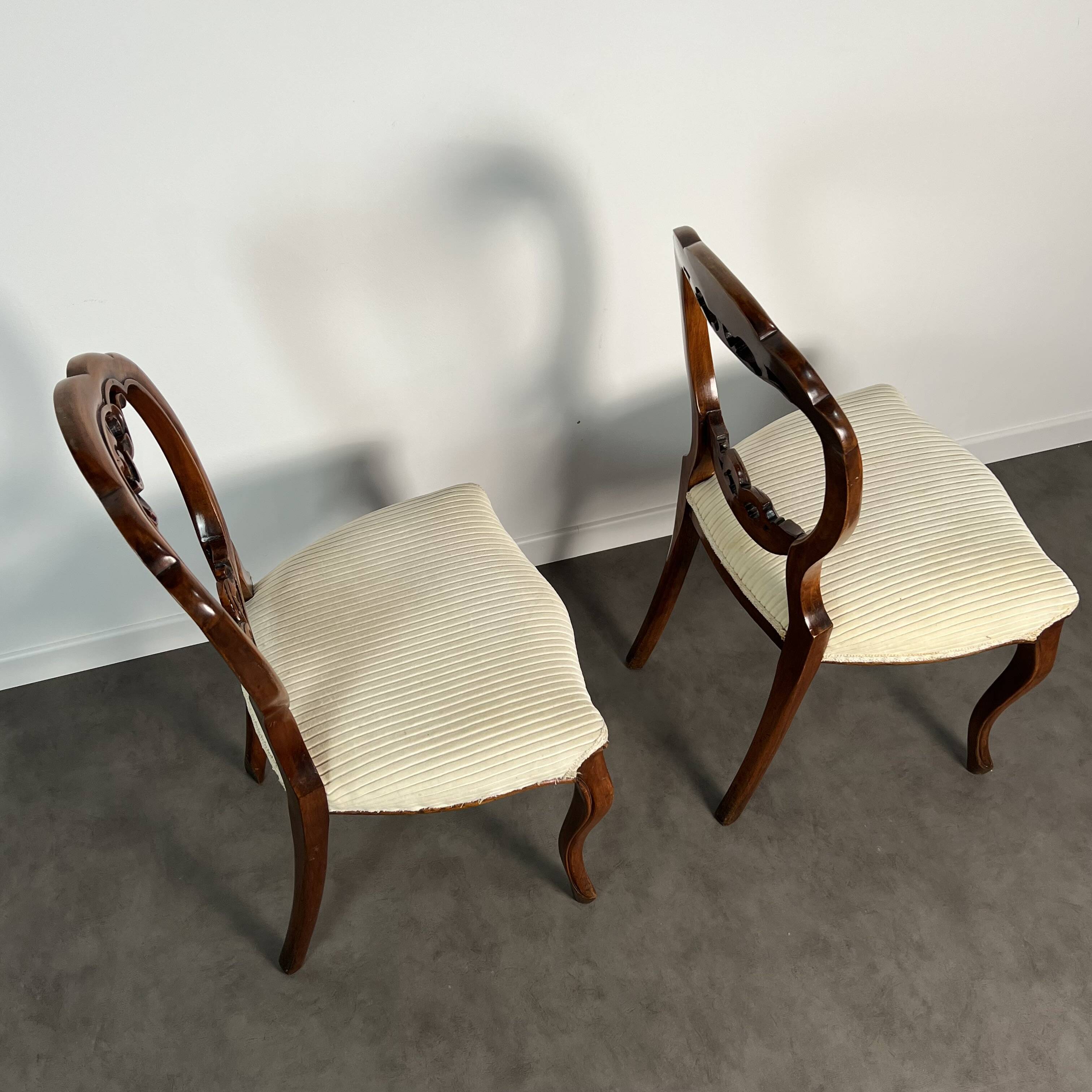 Pair of Victorian English chairs known as balloon chairs in solid mahogany.