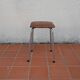 Stool covered in faux leather.