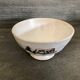 Old bowl decorated with a farmer and her cow