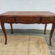 Louis XV style desk in wood, with a brown leather top.