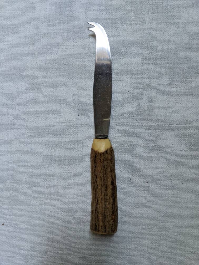 Vintage cheese knife with wood effect handle and country decor