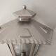 Half grey metal wall sconce and 3 windows