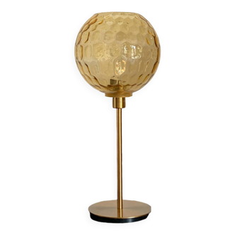 Table lamp with an antique vintage gold globe, mounted on a gold base