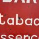 Tole sign painted "bar tobacco essence hairstyle"