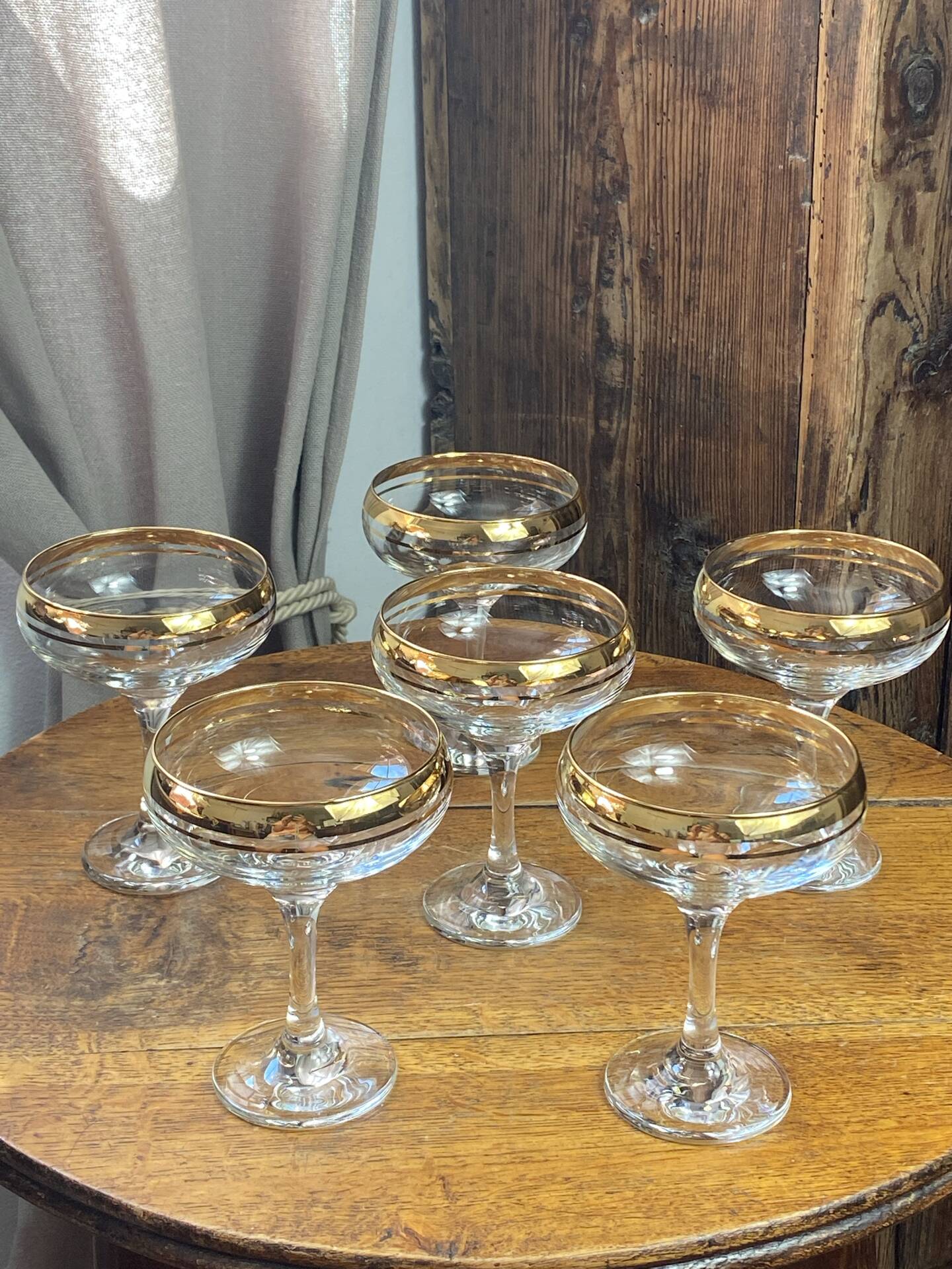 Champagne coupes or cocktail glasses with gilding
