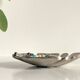Leaf-shaped metal pocket emptier