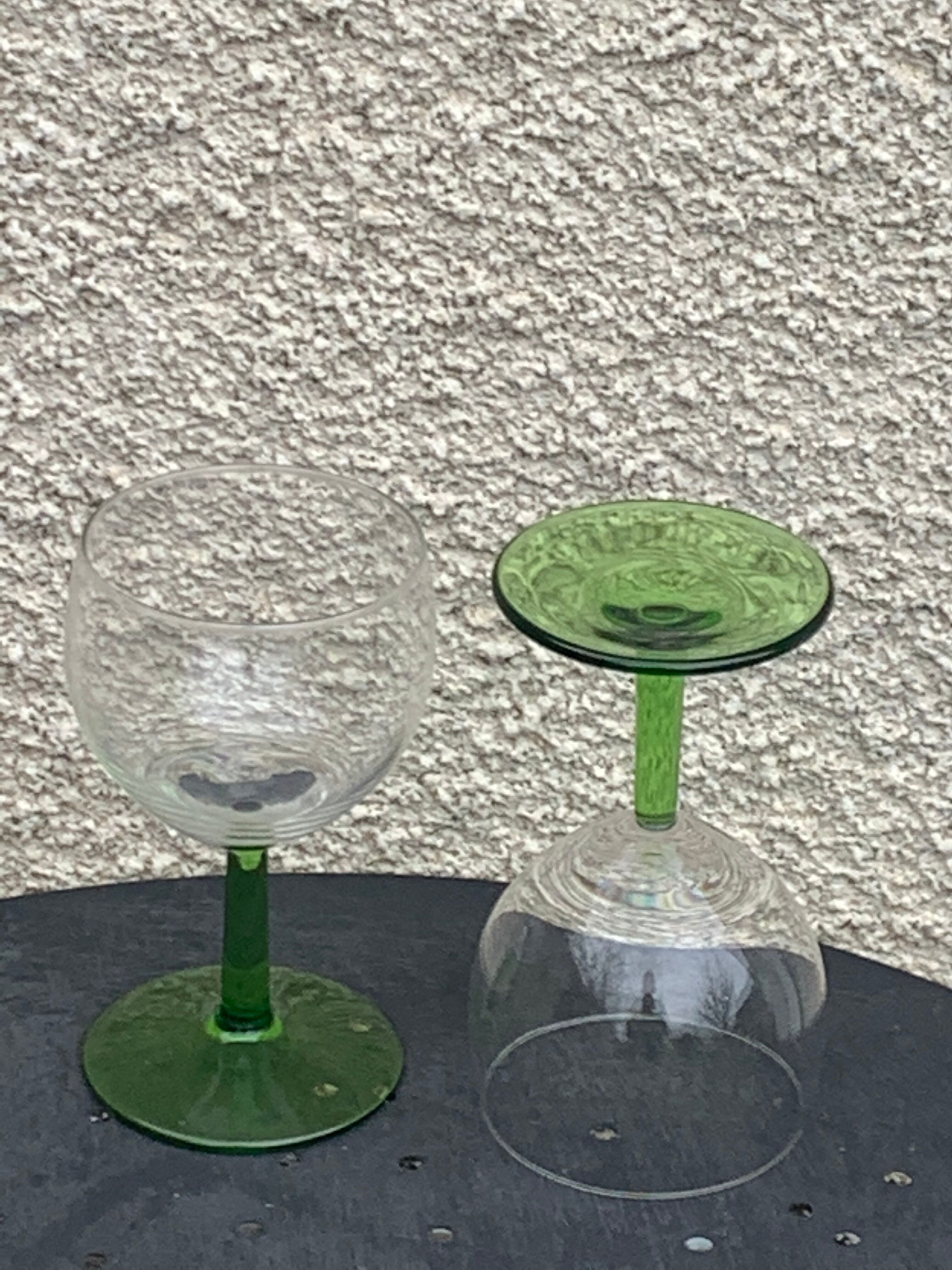 5 transparent glass glasses and green glass vase go