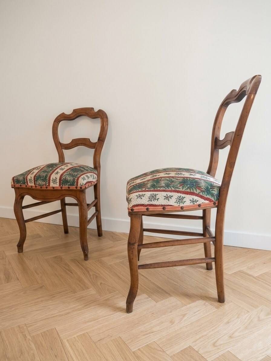 Pair of antique Louis XV style chairs in wood and floral fabric.