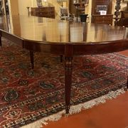 Extensible dining table from the Louis XVI period in mahogany with a banded top.