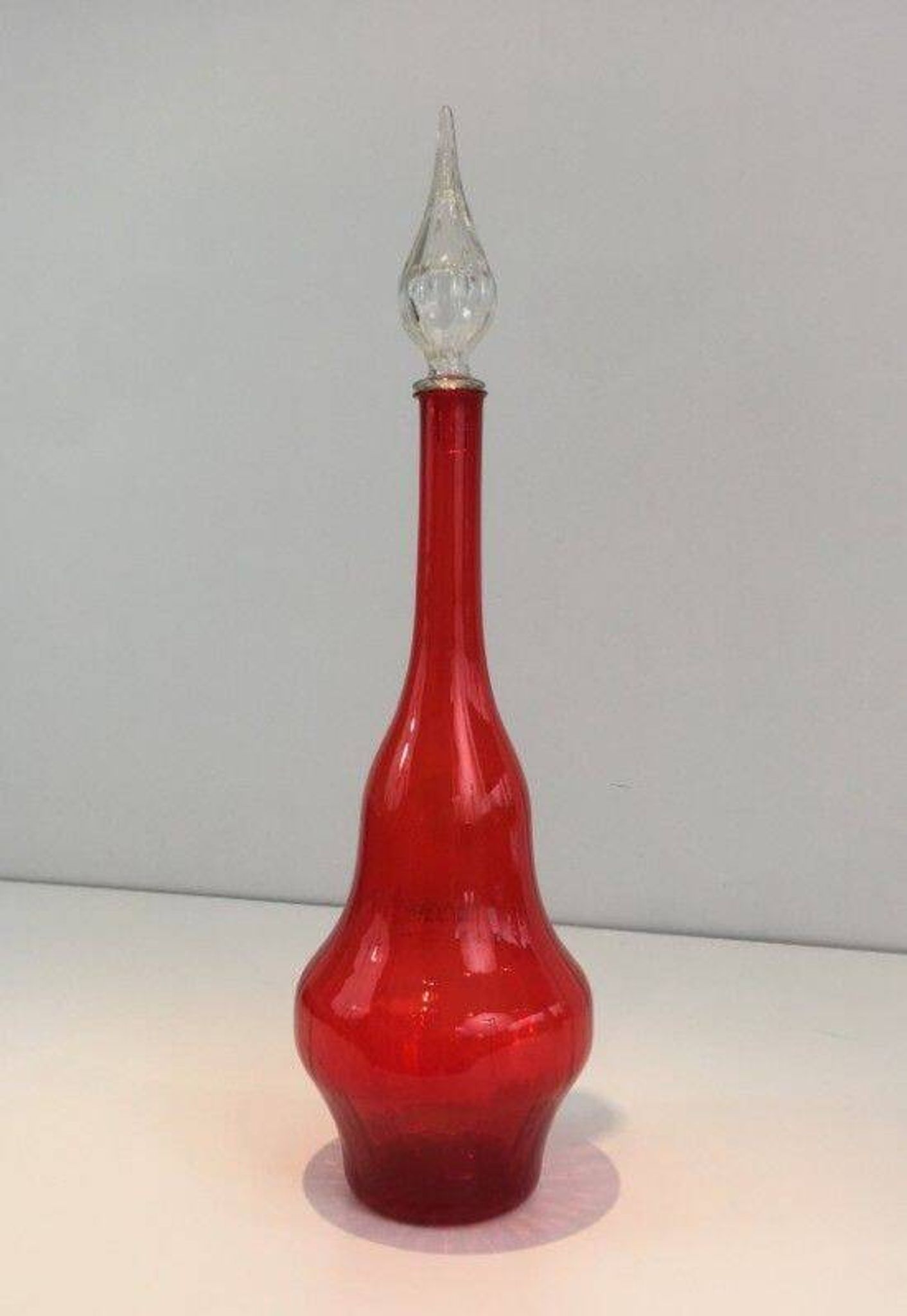 Large designer bottle in red glass