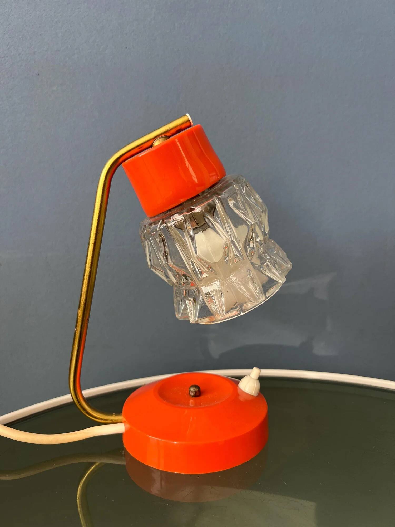 Small orange desk lamp with clear crystal glass shade