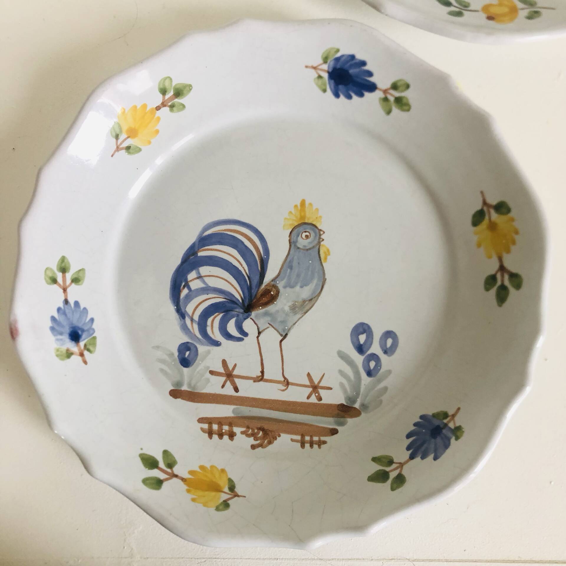 Pair of plates with naive Eastern rooster decoration