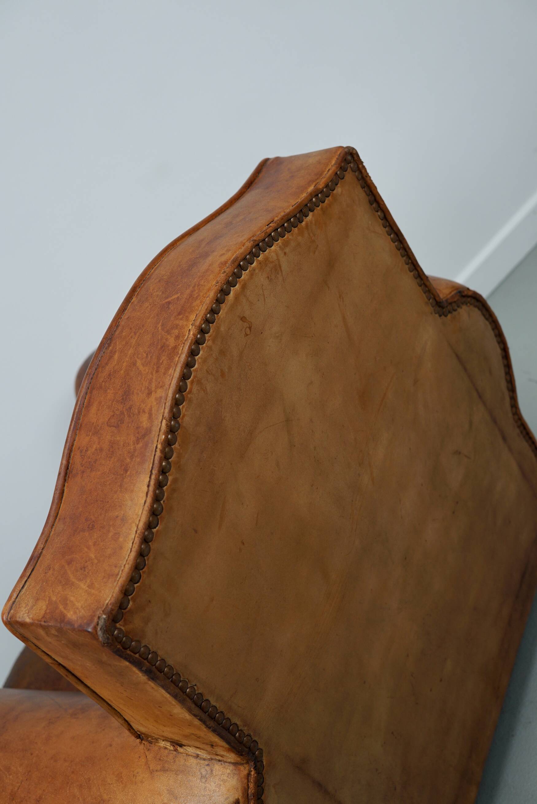 French moustache back cognac-colored leather club chair, 1940s