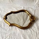 Old small wall mirror in golden resin