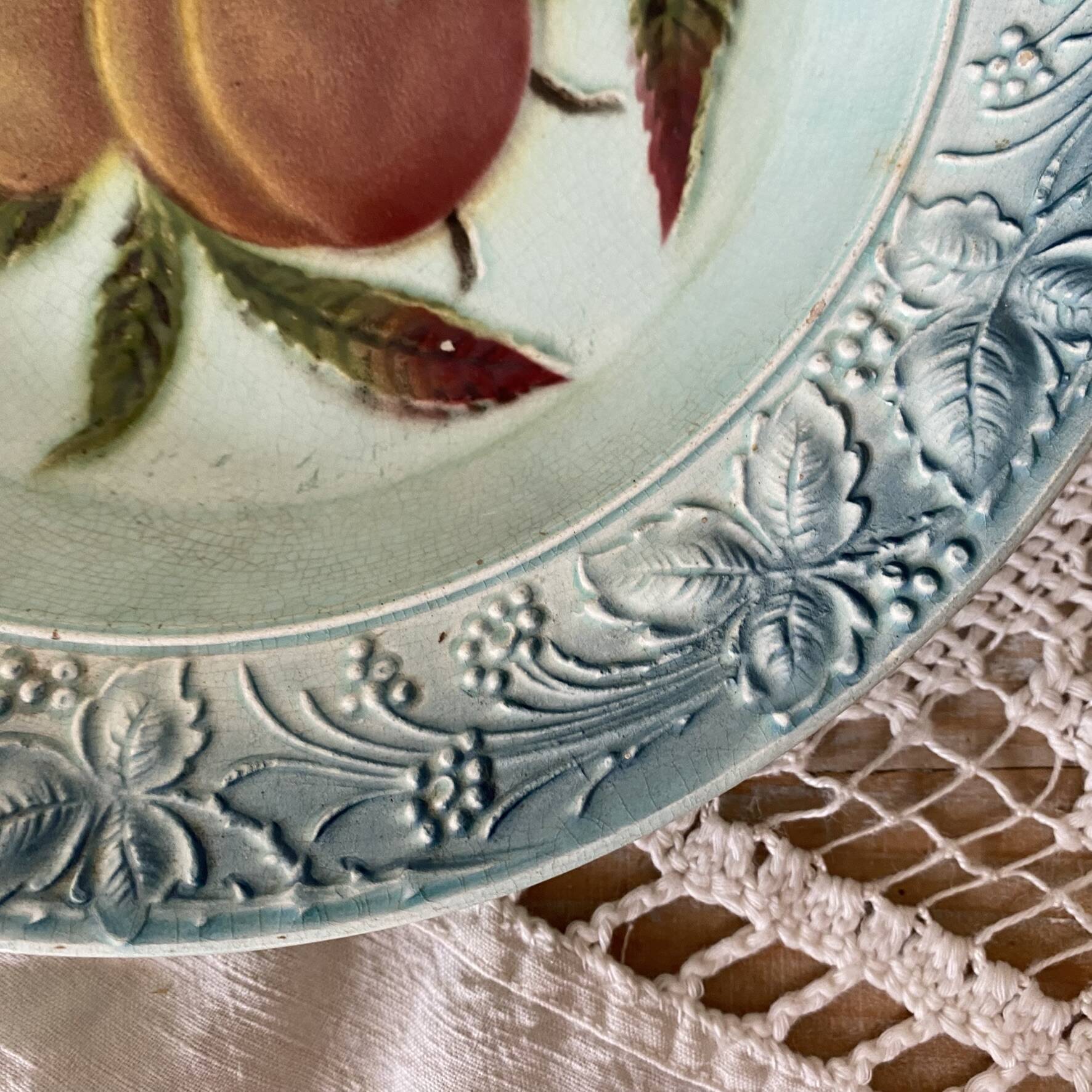 Shallow dish in slip with fruit decoration of peaches.