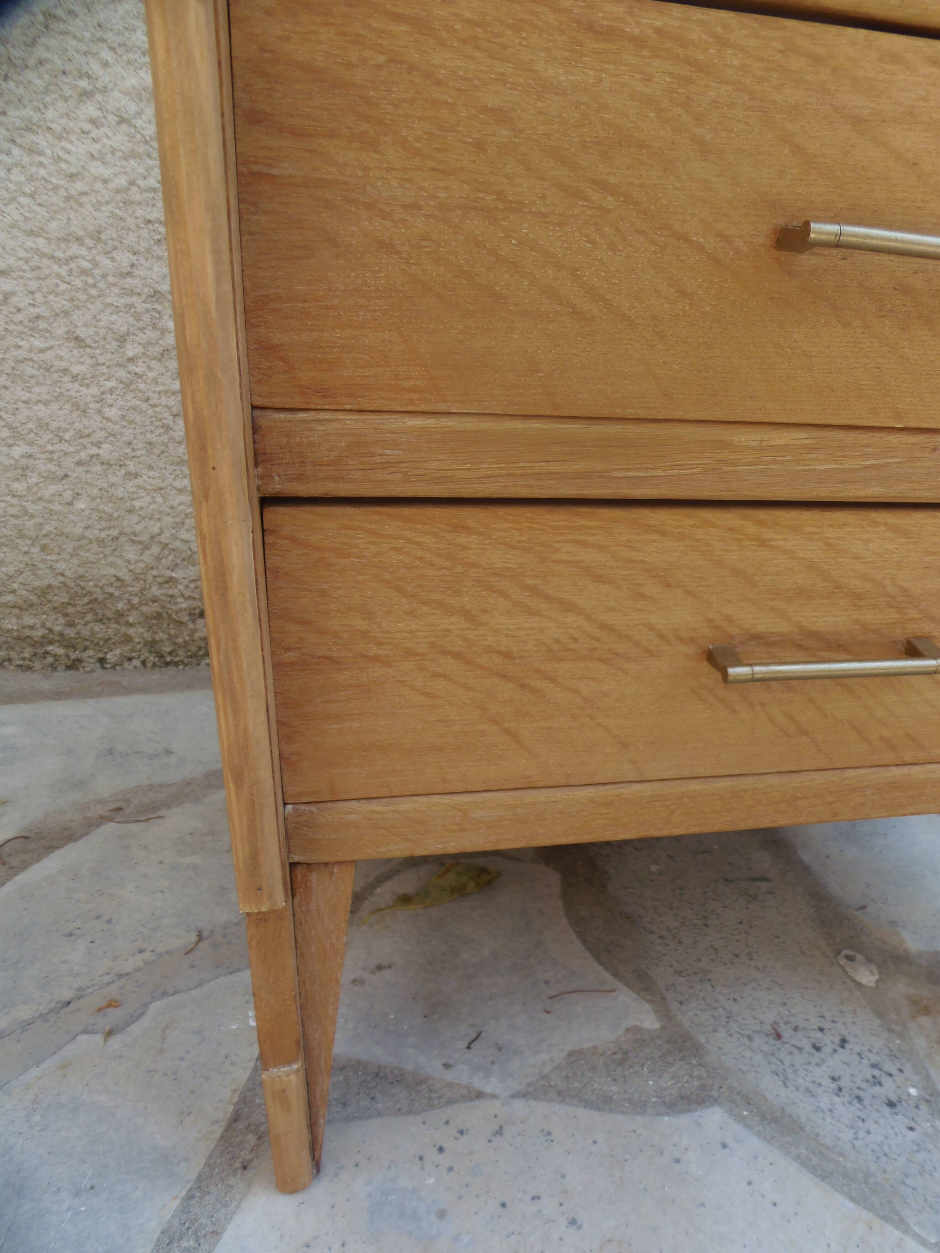 Vintage chest of drawers in raw wood.