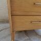 Vintage chest of drawers in raw wood.